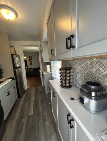 a kitchen with stainless steel appliances a sink stove and refrigerator