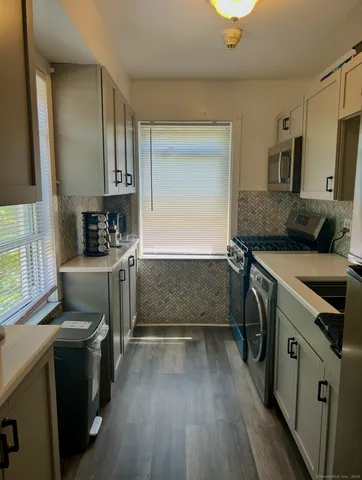 a kitchen with a sink stove and cabinets