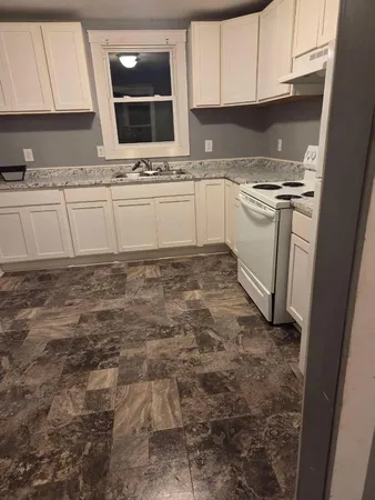 a kitchen with stainless steel appliances granite countertop a sink stove and cabinets