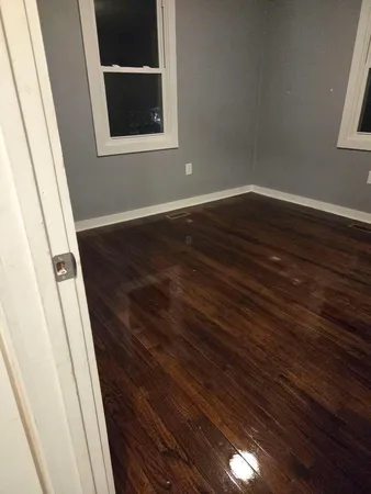 a view of a hallway in a house with wooden floor