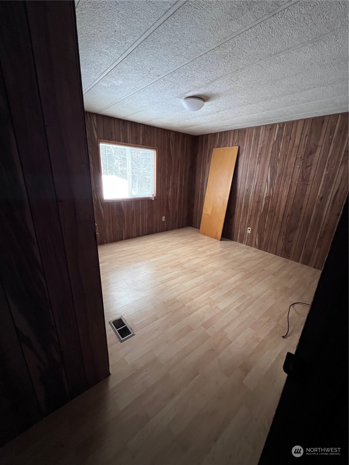 2408 Newberg Road Snohomish, WA 98290 - Photo 14 of 32 a view of an empty room with wooden floor and a window