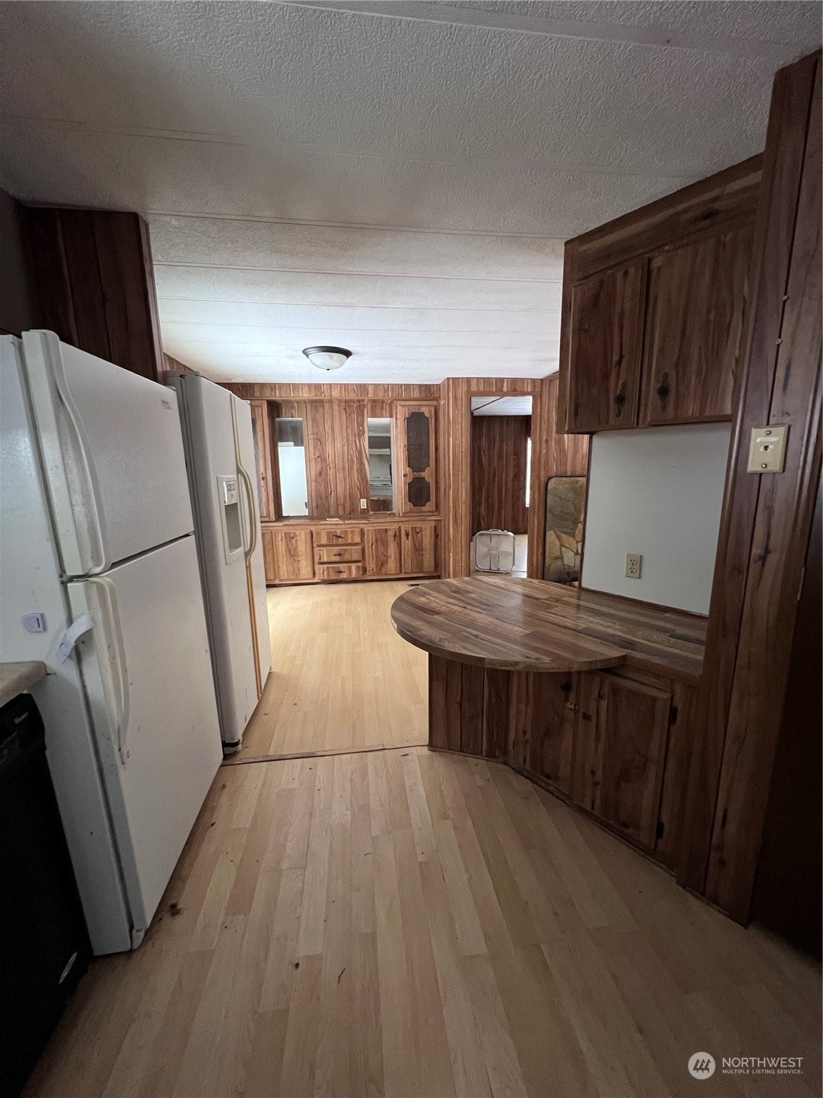 2408 Newberg Road Snohomish, WA 98290 - Photo 17 of 32 a kitchen with a refrigerator and wooden floor