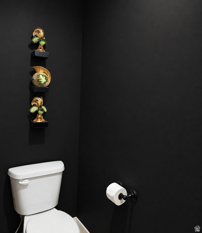 774 West 480 South American Fork, UT 84003 - Photo 70 of 76 White porcelain toilet with a dark-finished toilet paper holder against a black wall