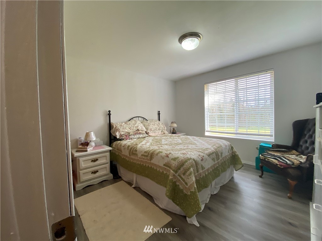 761 East Victor Road Belfair, WA 98528 - Photo 14 of 33 a bedroom with a bed and wooden floor