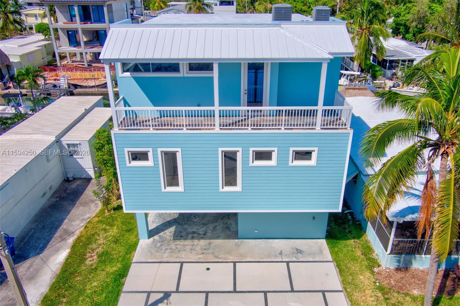 84 Coral Way Key Largo, FL 33037 - Photo 3 of 55 a front view of a house with a yard