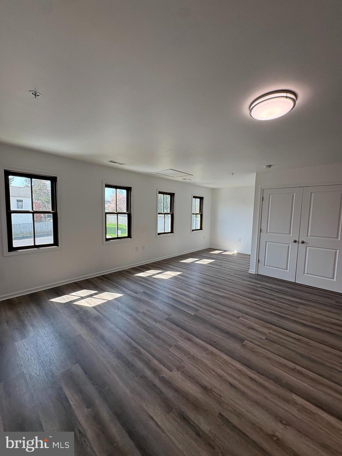 106 West All Saints Street, Unit B2 Frederick, MD 21701 - Photo 16 of 16 an empty room with wooden floor and windows