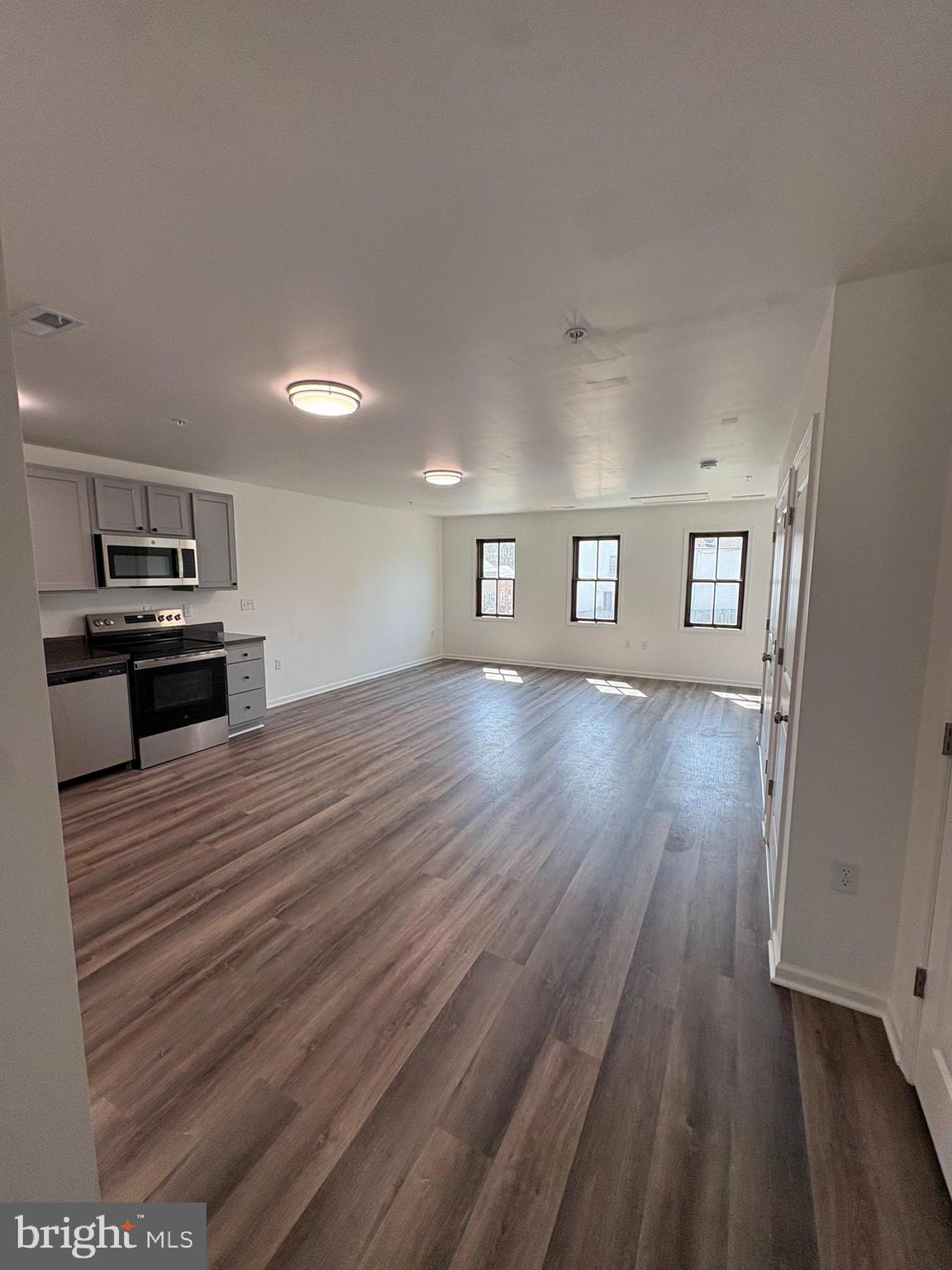 106 West All Saints Street, Unit B2 Frederick, MD 21701 - Photo 7 of 16 a view of a kitchen with wooden floor and electronic appliances
