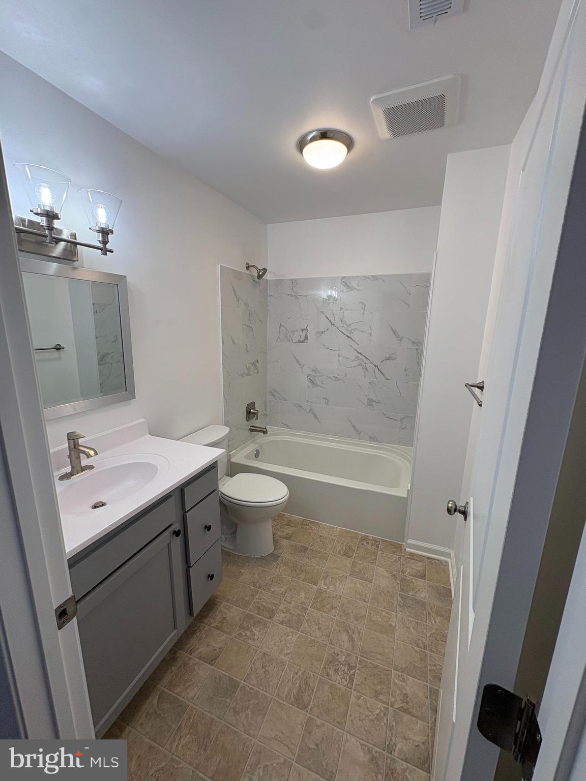 106 West All Saints Street, Unit B2 Frederick, MD 21701 - Photo 10 of 16 a bathroom with a double vanity sink toilet and shower
