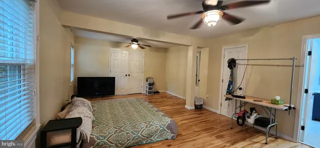 a bed room with a bed and a flat tv screen on a table