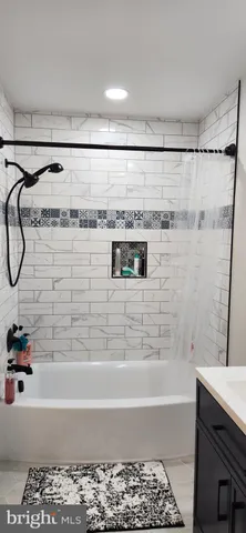 a bathroom with a bathtub and a shower