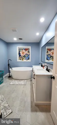 a bathroom with a double vanity sink and a mirror