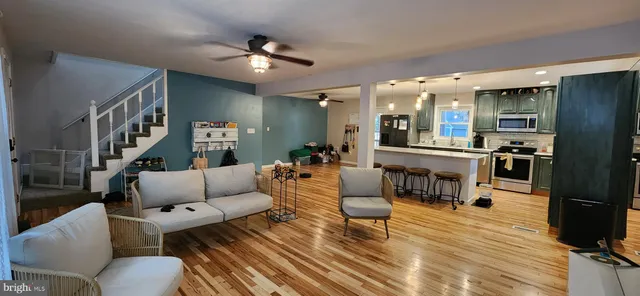 a living room with furniture and kitchen view
