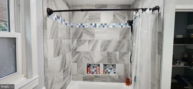a bathroom with a shower and a tub