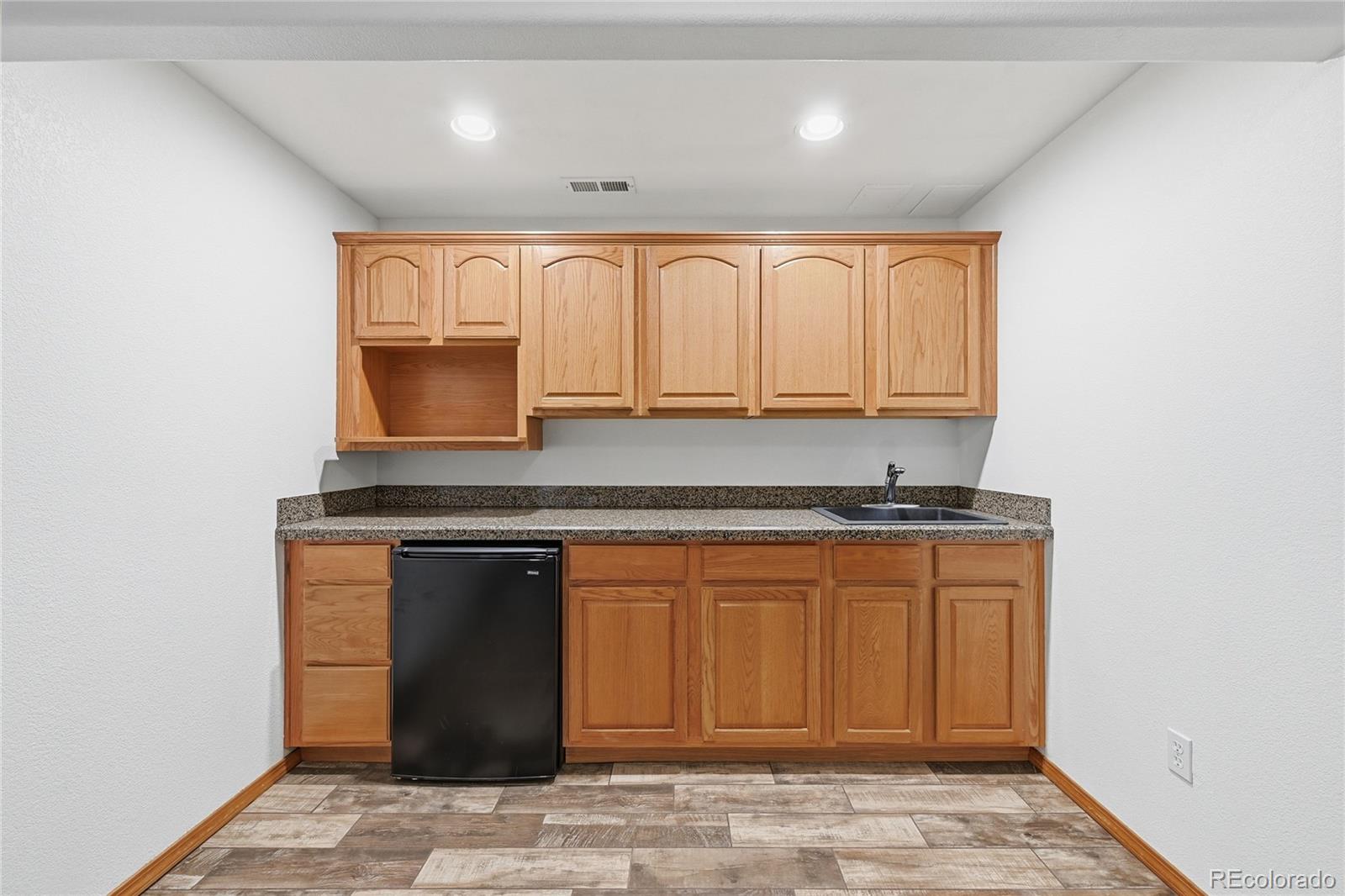 9288 Rockingham Drive Peyton, CO 80831 - Photo 29 of 49 a kitchen with stainless steel appliances granite countertop a stove a sink and a microwave