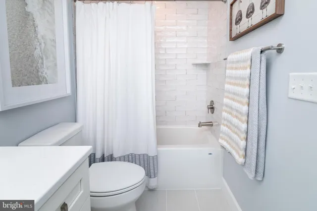 a bathroom with a toilet and a bathtub