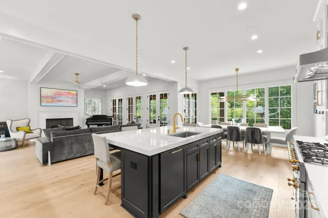 a large kitchen with kitchen island a sink a counter top space and stainless steel appliances