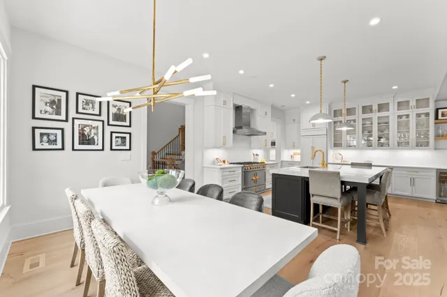 a large kitchen with a table and chairs