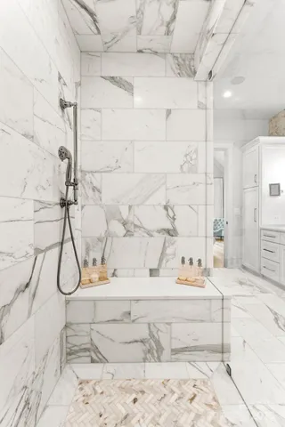 a bathroom with a bathtub and shower