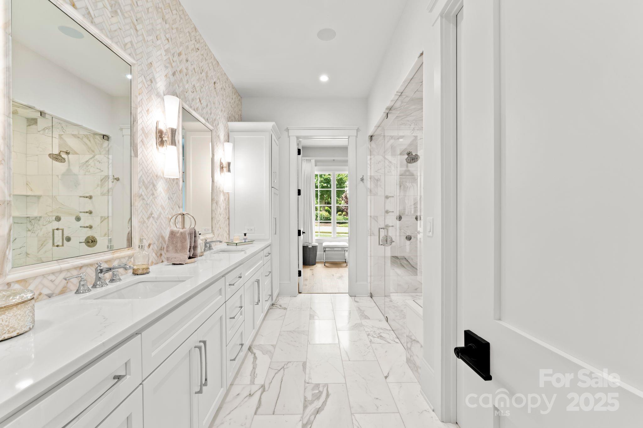 21216 Olde Quarry Lane Cornelius, NC 28031 - Photo 20 of 48 a spacious bathroom with a sink a toilet a shower and a mirror