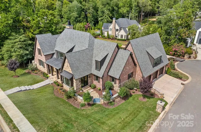 an aerial view of a house with big yard