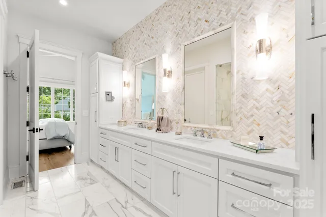 a en suite bathroom with a double sink and mirror