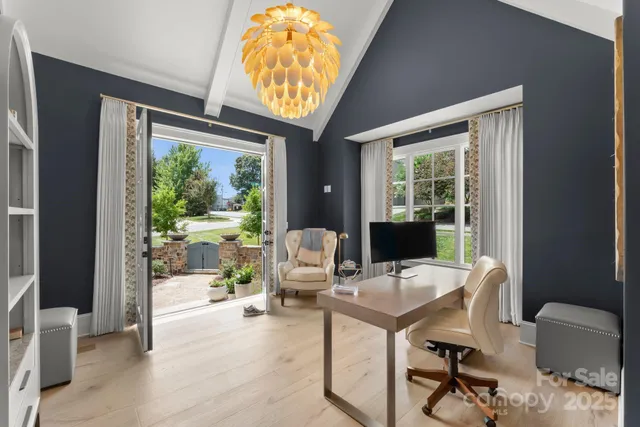 a work room with furniture and a large window