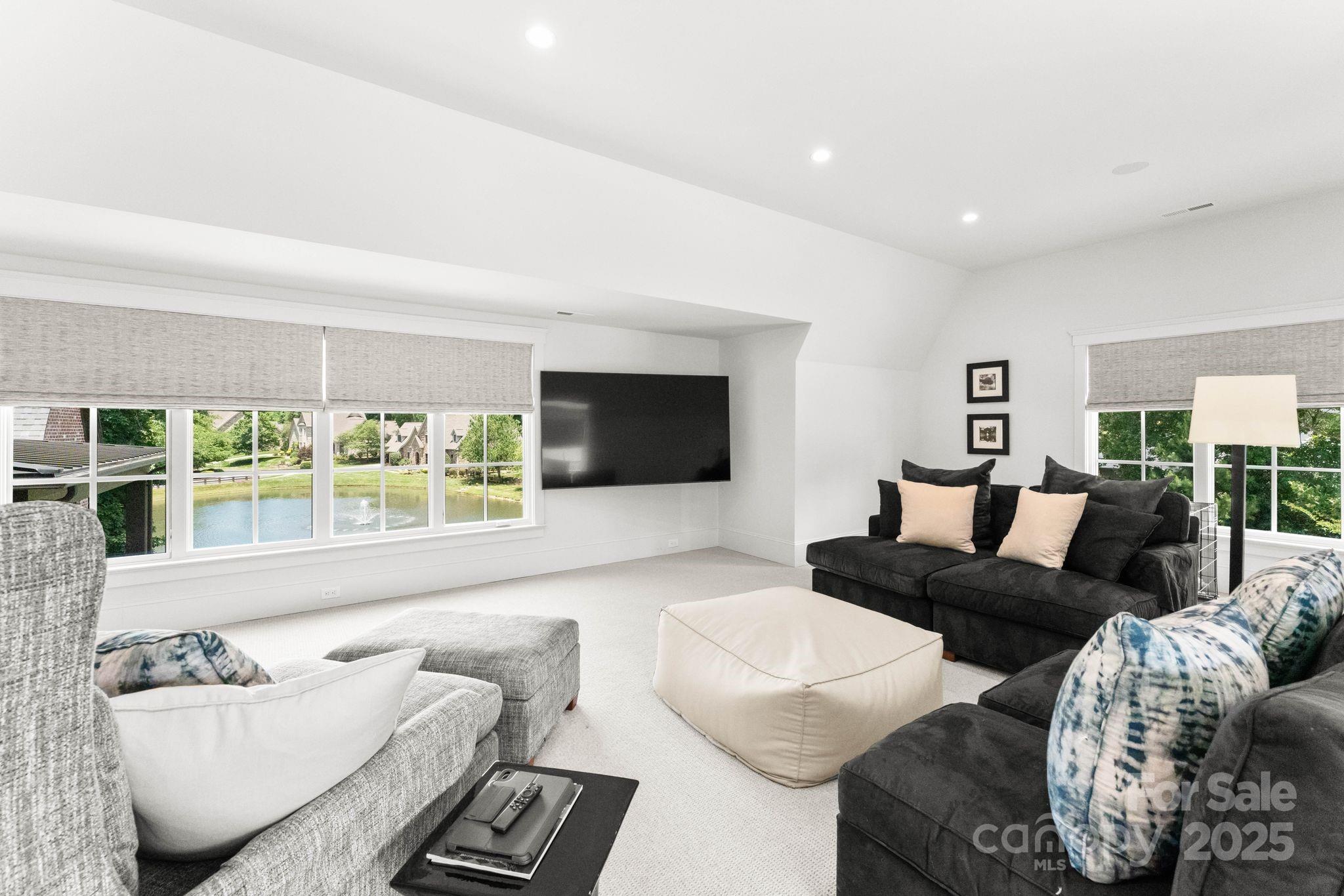 21216 Olde Quarry Lane Cornelius, NC 28031 - Photo 32 of 48 a living room with furniture and a flat screen tv