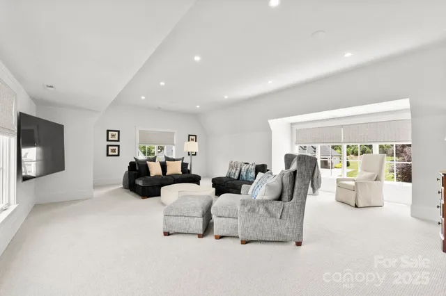 a living room with furniture a fireplace and a large window