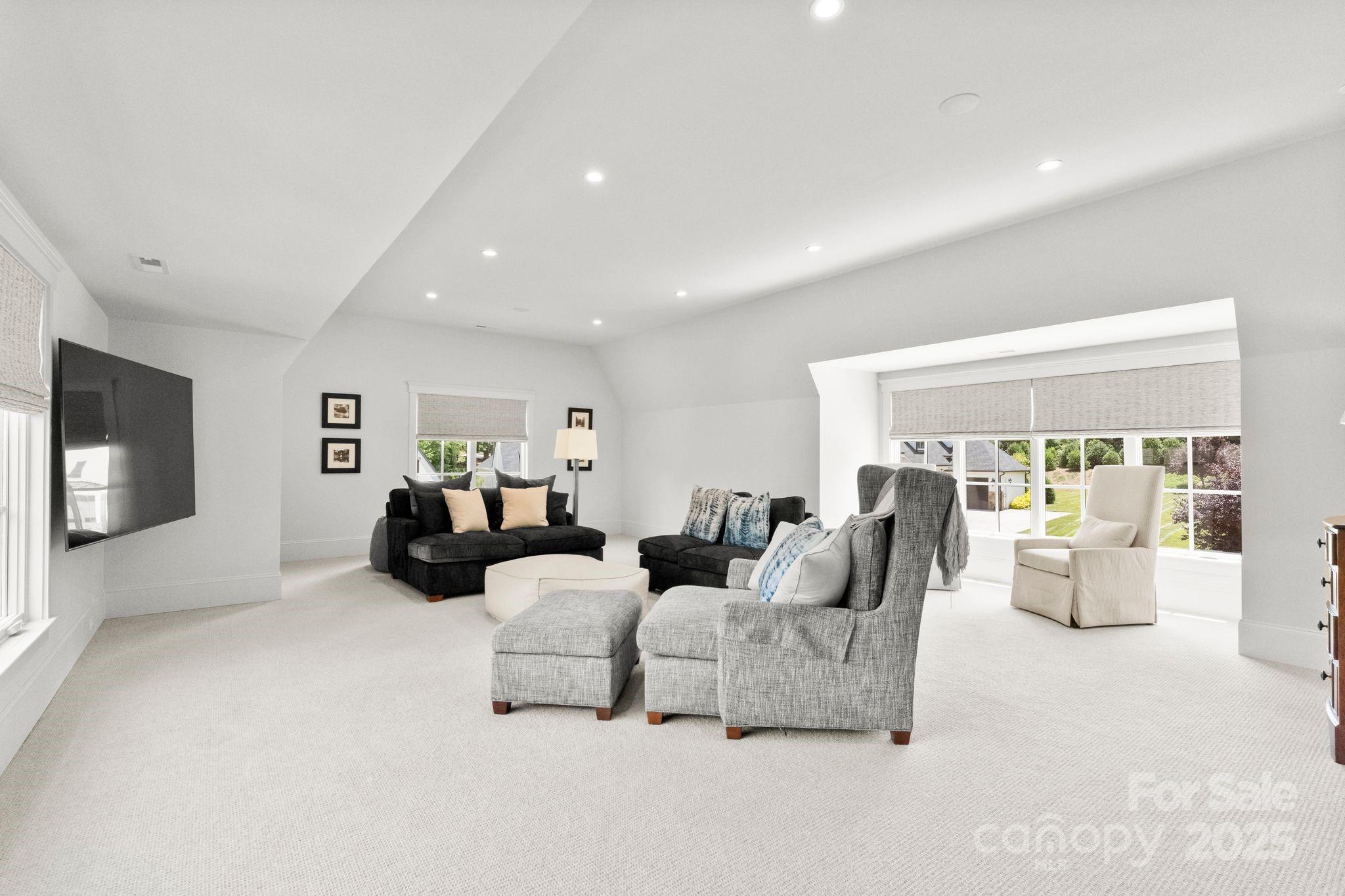 21216 Olde Quarry Lane Cornelius, NC 28031 - Photo 33 of 48 a living room with furniture a fireplace and a large window