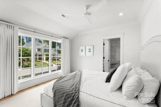a bedroom with a large bed and a large window