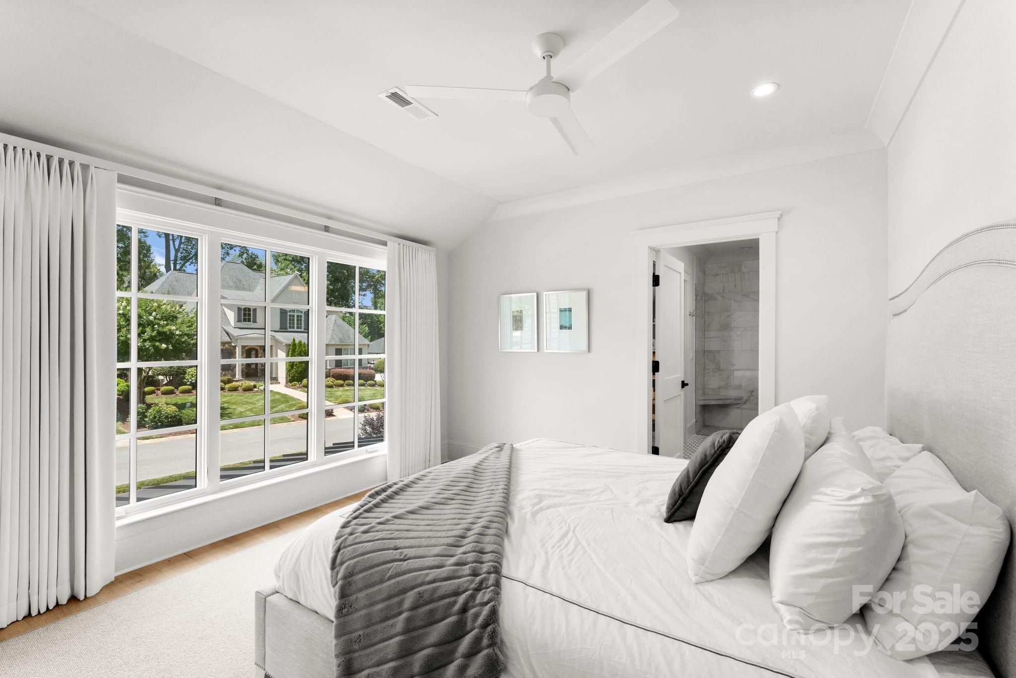 21216 Olde Quarry Lane Cornelius, NC 28031 - Photo 35 of 48 a bedroom with a large bed and a large window