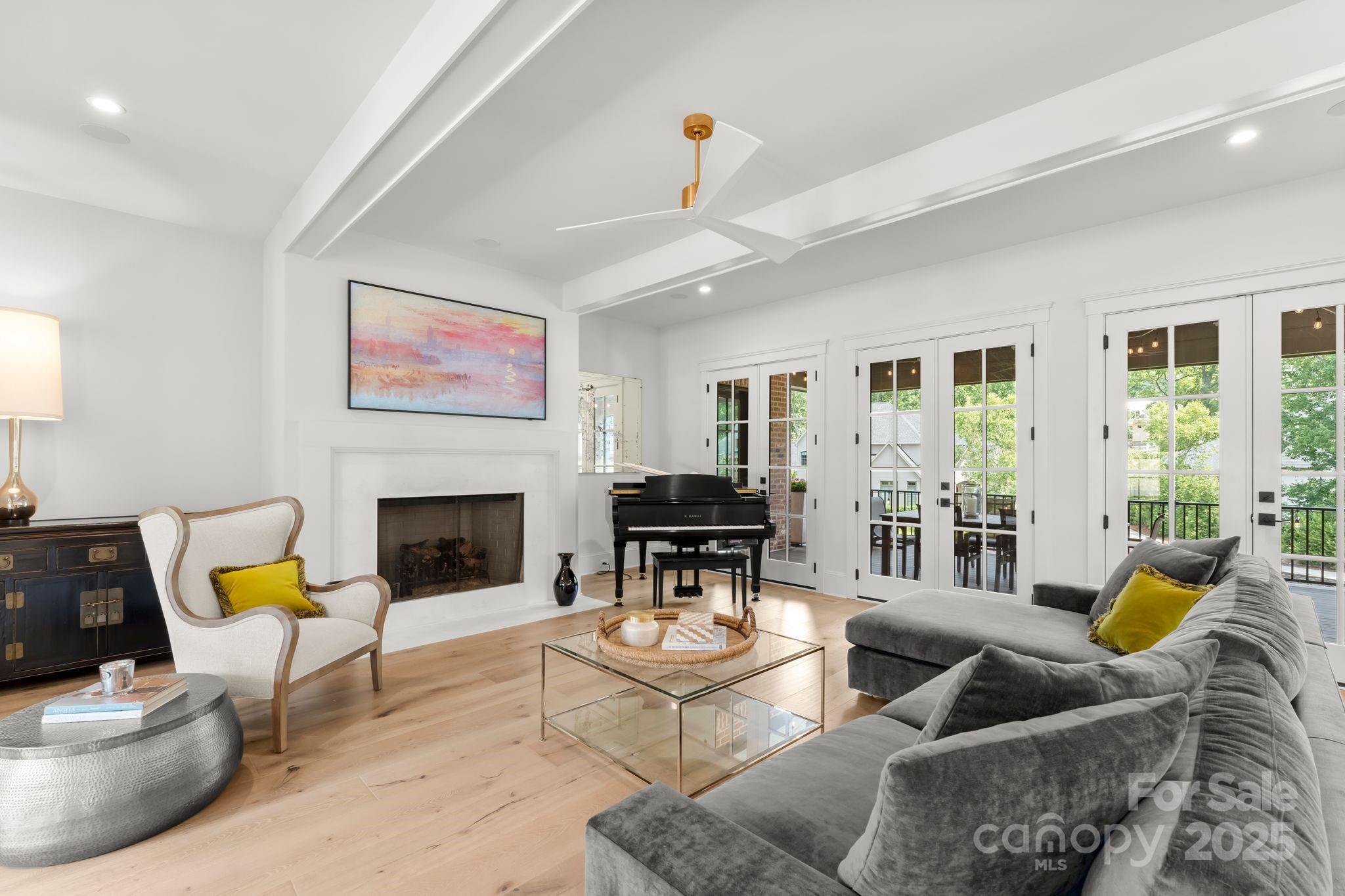 21216 Olde Quarry Lane Cornelius, NC 28031 - Photo 7 of 48 a living room with furniture a fireplace and a potted plant