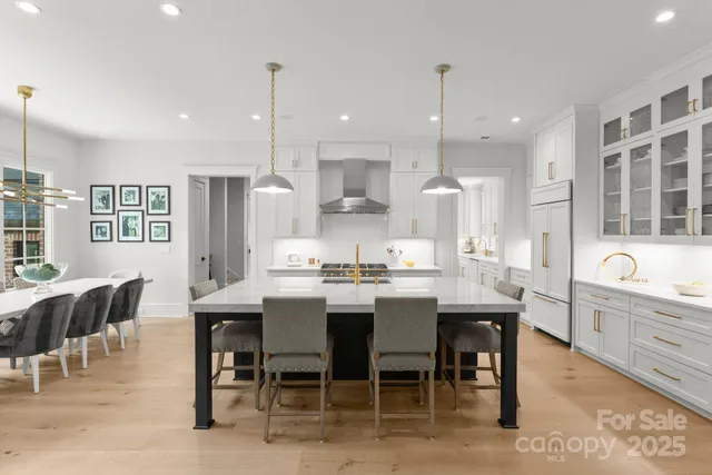 a large kitchen with a table and chairs