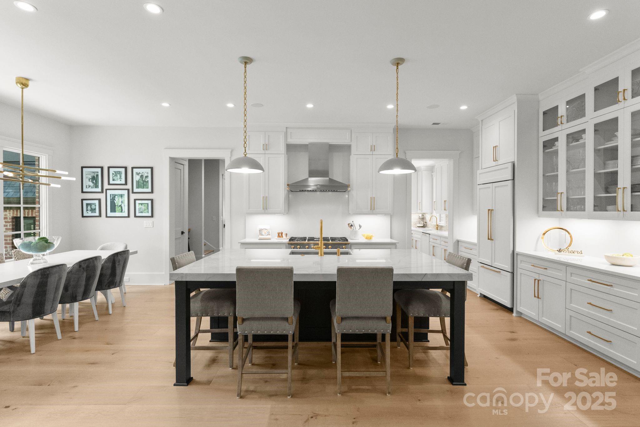 21216 Olde Quarry Lane Cornelius, NC 28031 - Photo 10 of 48 a large kitchen with a table and chairs