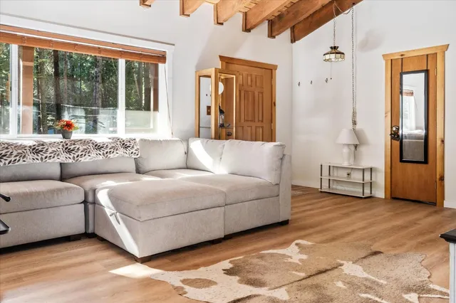 a living room with furniture and large windows