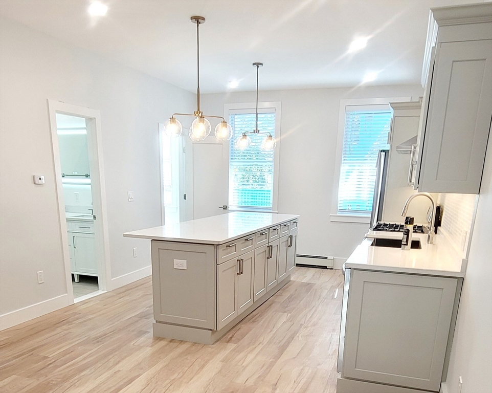 53 West Eagle Street, Unit 2 Boston, MA 02128 - Photo 3 of 7 a kitchen with sink stove and refrigerator