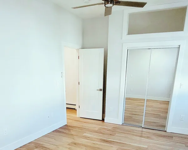 a view of a closet area with wooden floor