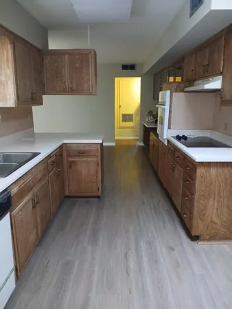 a kitchen with wooden cabinets and a sink