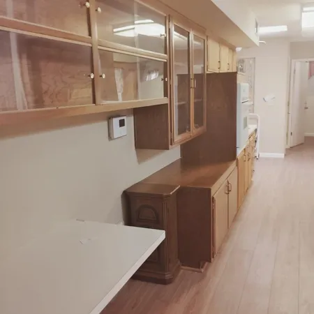 a kitchen with stainless steel appliances a refrigerator and wooden cabinets