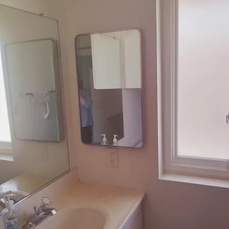 view of a bathroom with a sink and mirror
