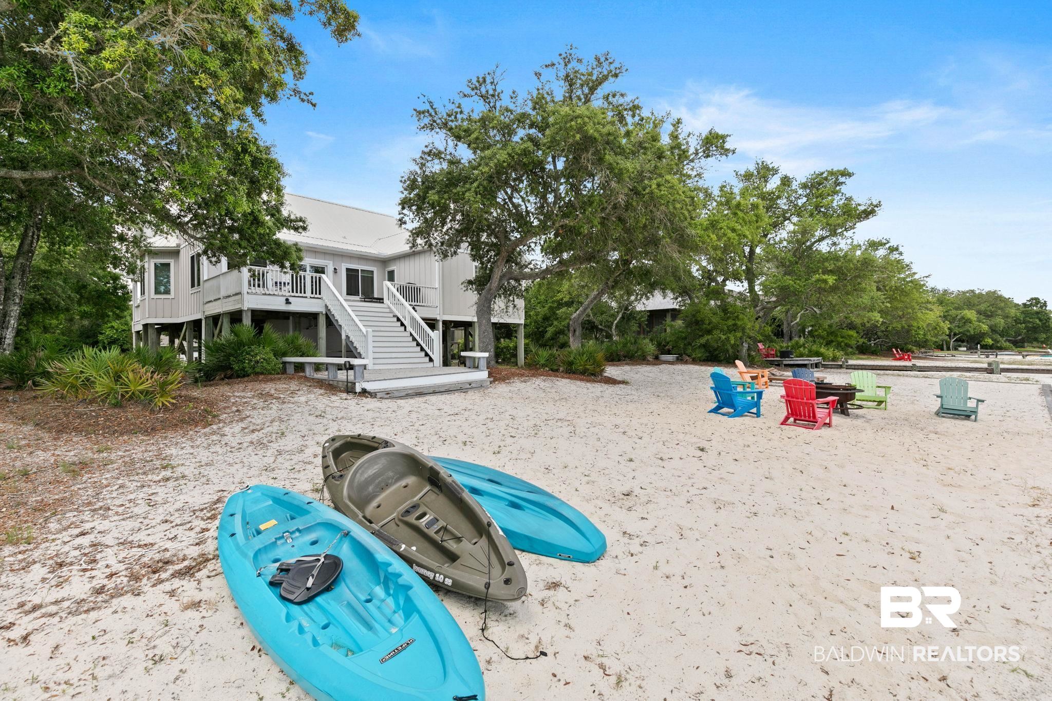 6802 Shore Drive Elberta, AL 36530 - Photo 30 of 34 Elevated coastal residence featuring a spacious deck with direct stair access to a sandy beach