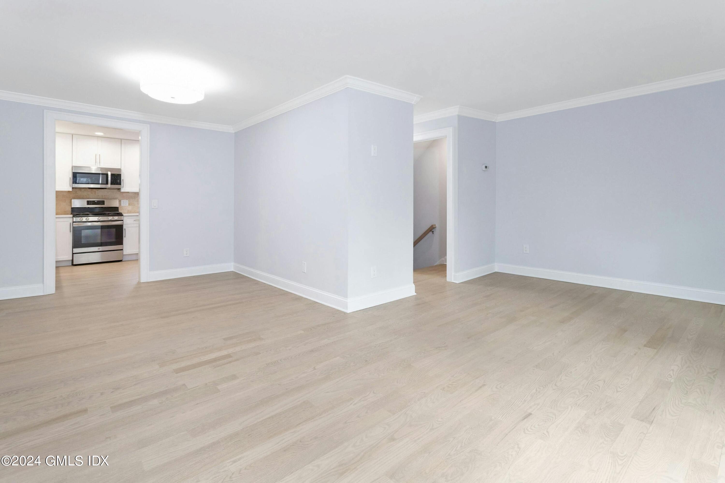 37 Sheep Hill Road, Unit 12 Riverside, CT 06878 - Photo 11 of 23 a view of empty room with wooden floor and entryway
