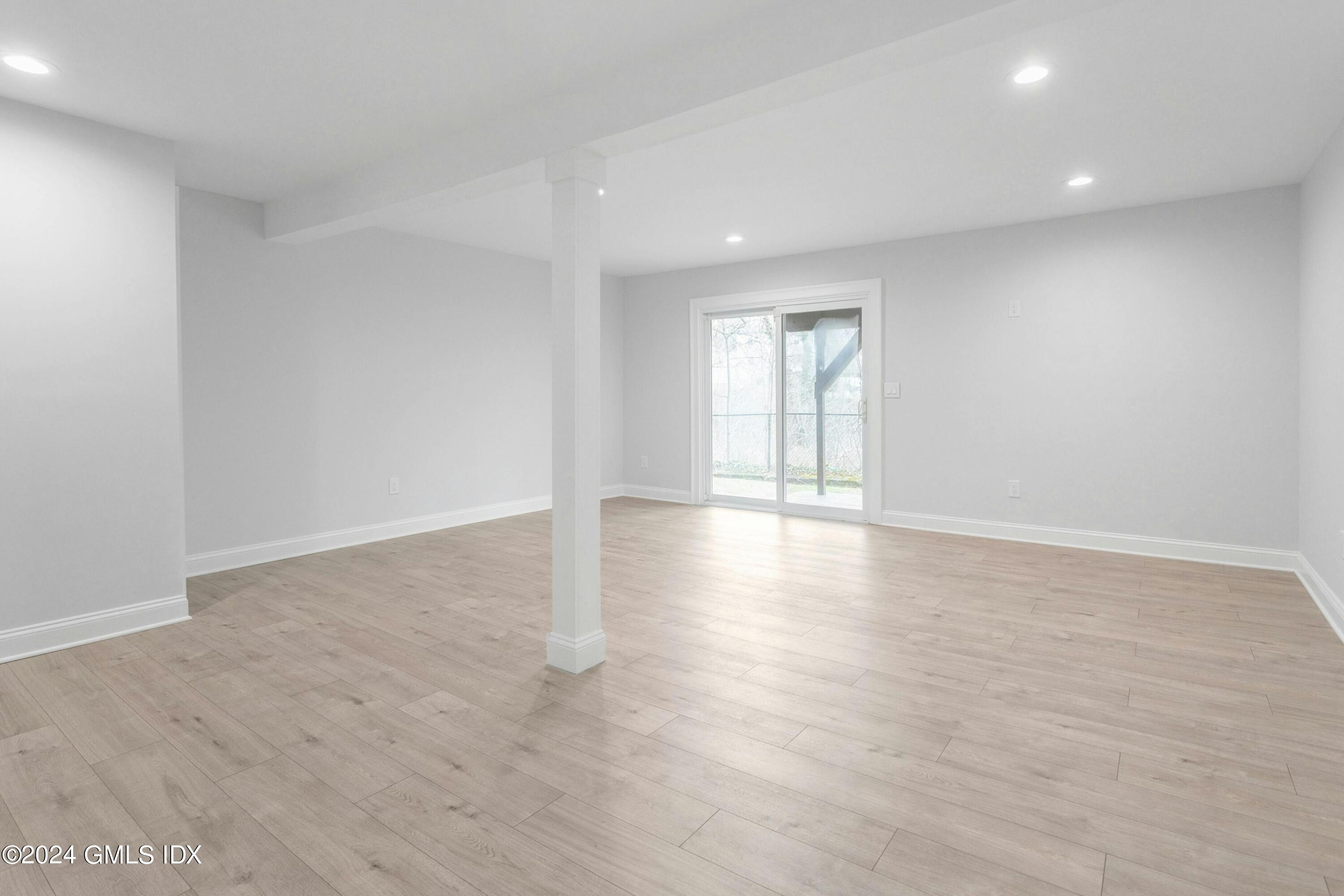 37 Sheep Hill Road, Unit 12 Riverside, CT 06878 - Photo 13 of 23 a view of an empty room with wooden floor and window