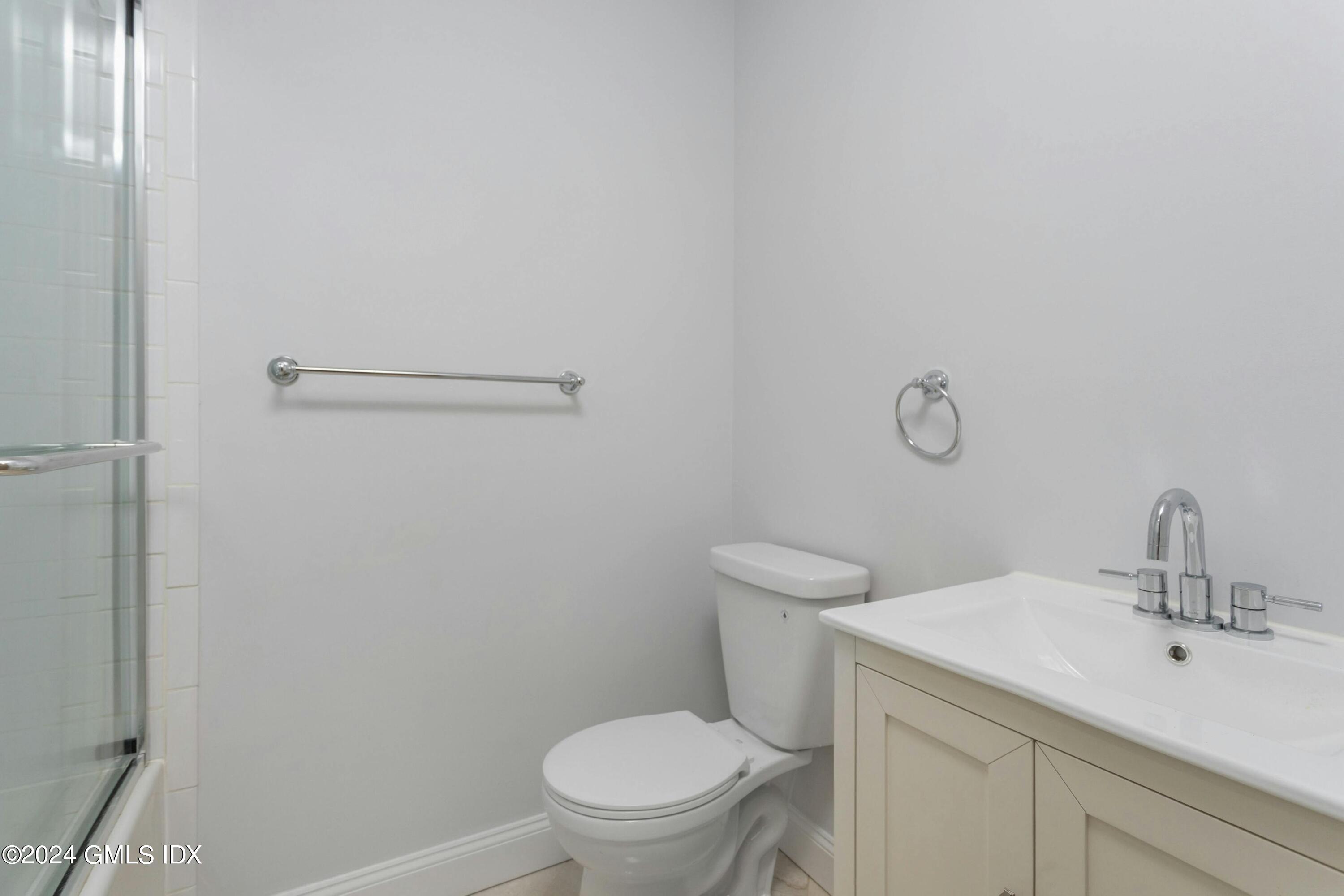 37 Sheep Hill Road, Unit 12 Riverside, CT 06878 - Photo 20 of 23 a bathroom with a toilet a sink and mirror