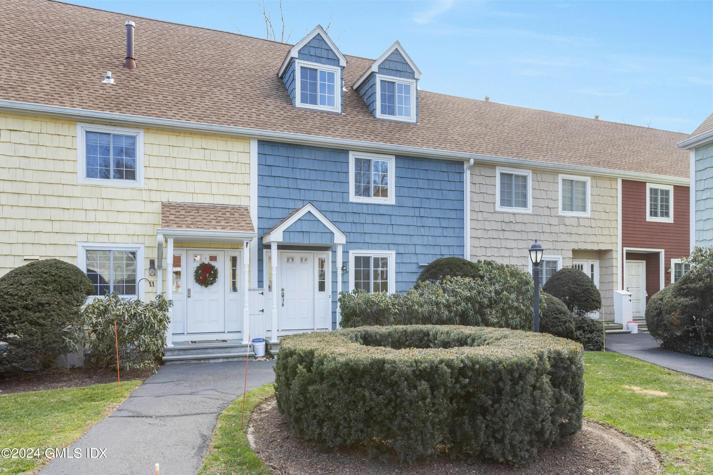 37 Sheep Hill Road, Unit 12 Riverside, CT 06878 - Photo 2 of 23 a front view of a house with a garden