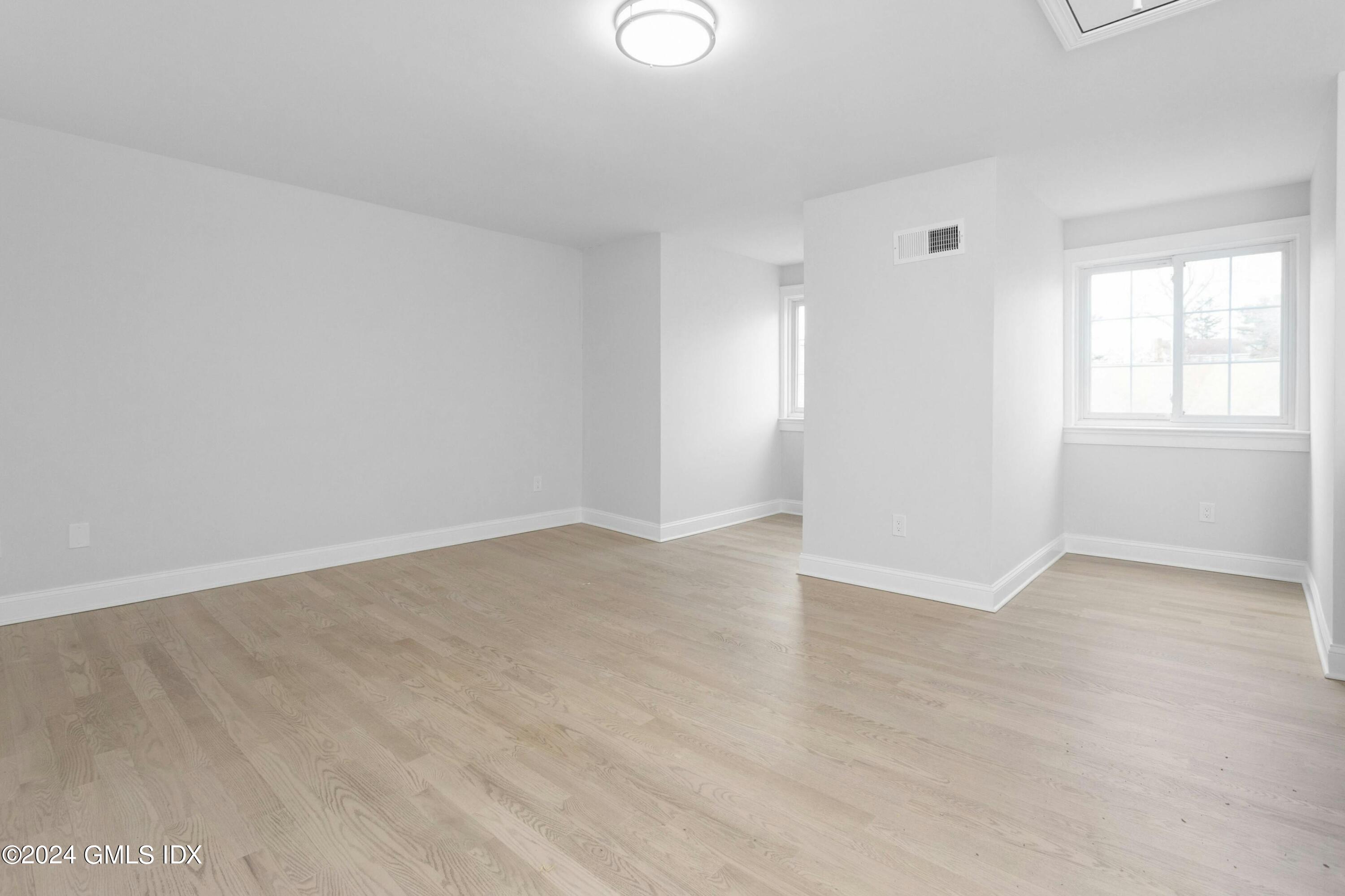 37 Sheep Hill Road, Unit 12 Riverside, CT 06878 - Photo 22 of 23 an empty room with windows and closet