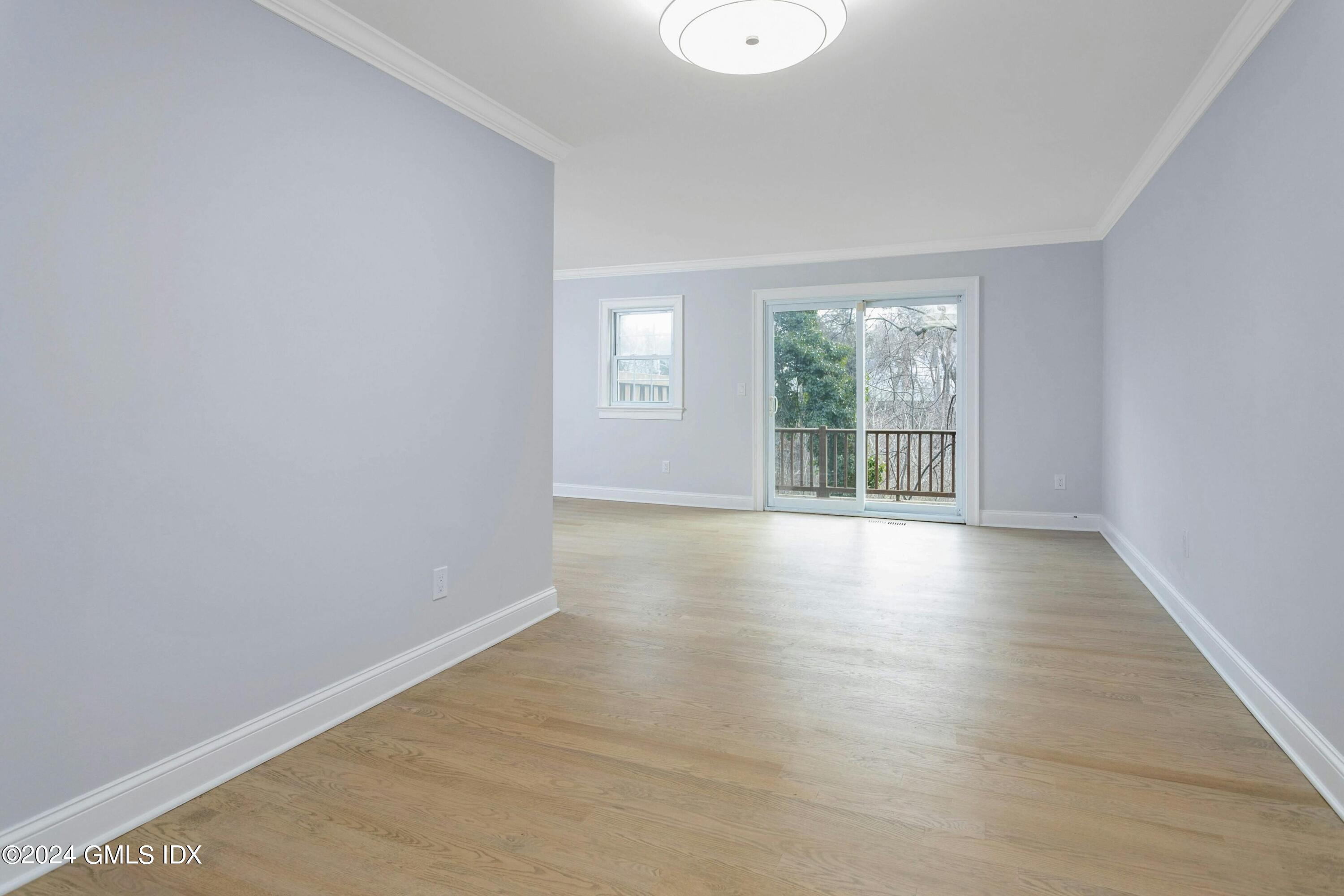 37 Sheep Hill Road, Unit 12 Riverside, CT 06878 - Photo 23 of 23 an empty room with wooden floor and windows