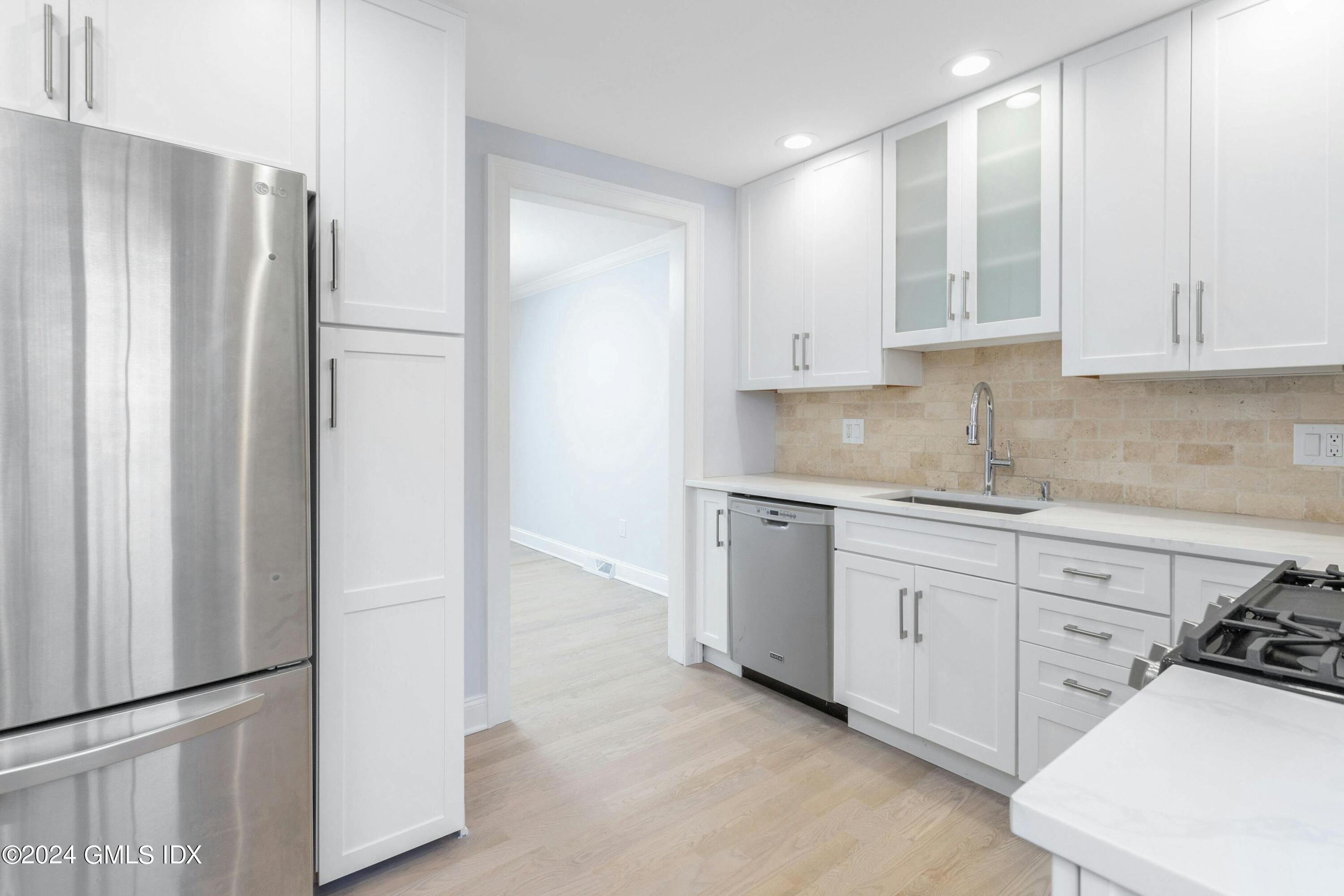37 Sheep Hill Road, Unit 12 Riverside, CT 06878 - Photo 5 of 23 a kitchen with stainless steel appliances granite countertop a refrigerator sink and cabinets