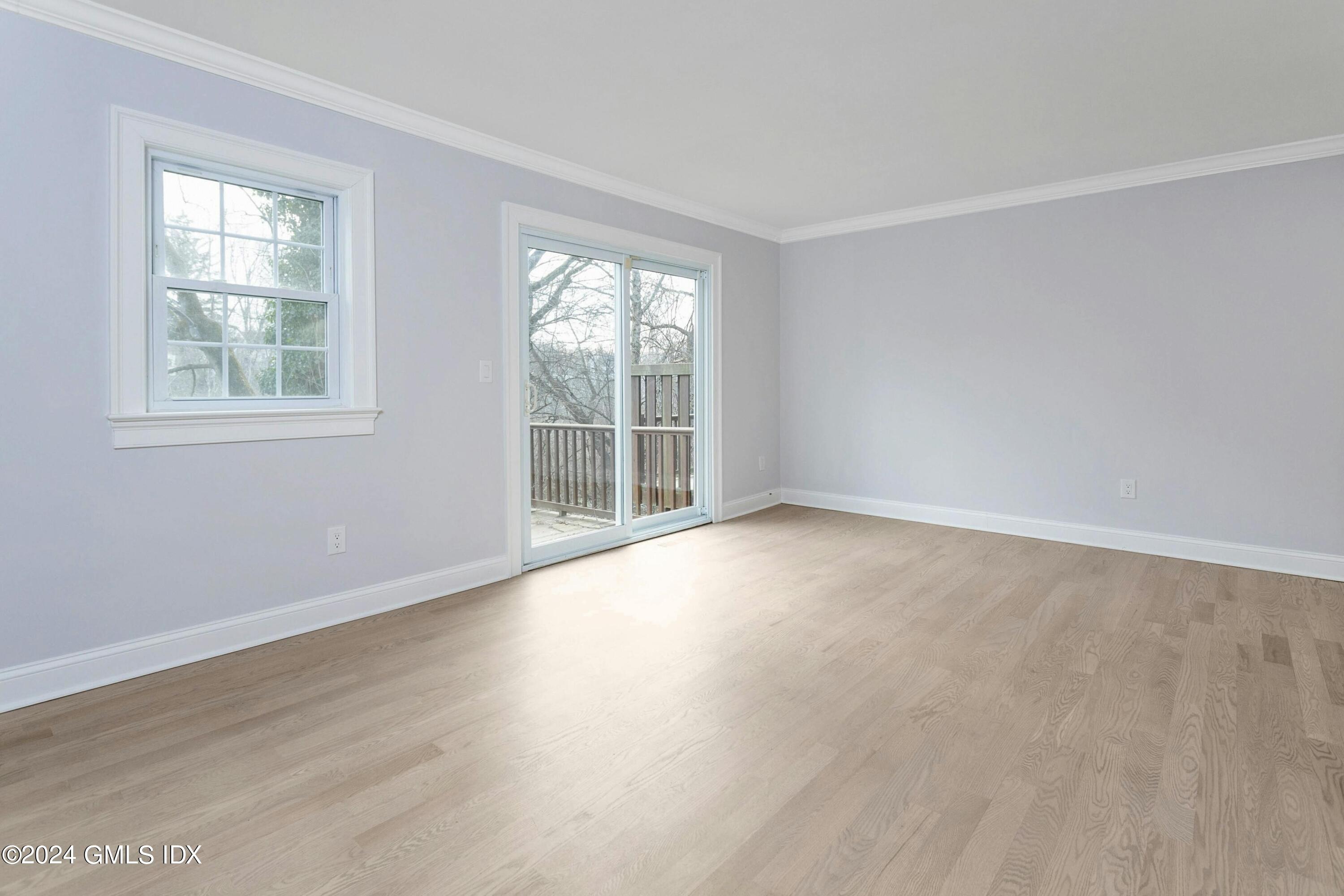 37 Sheep Hill Road, Unit 12 Riverside, CT 06878 - Photo 10 of 23 an empty room with wooden floor and windows