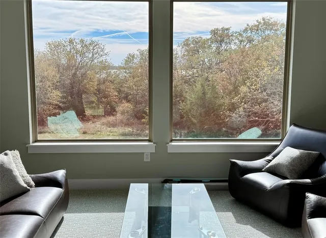 a view of a room with furniture and a window